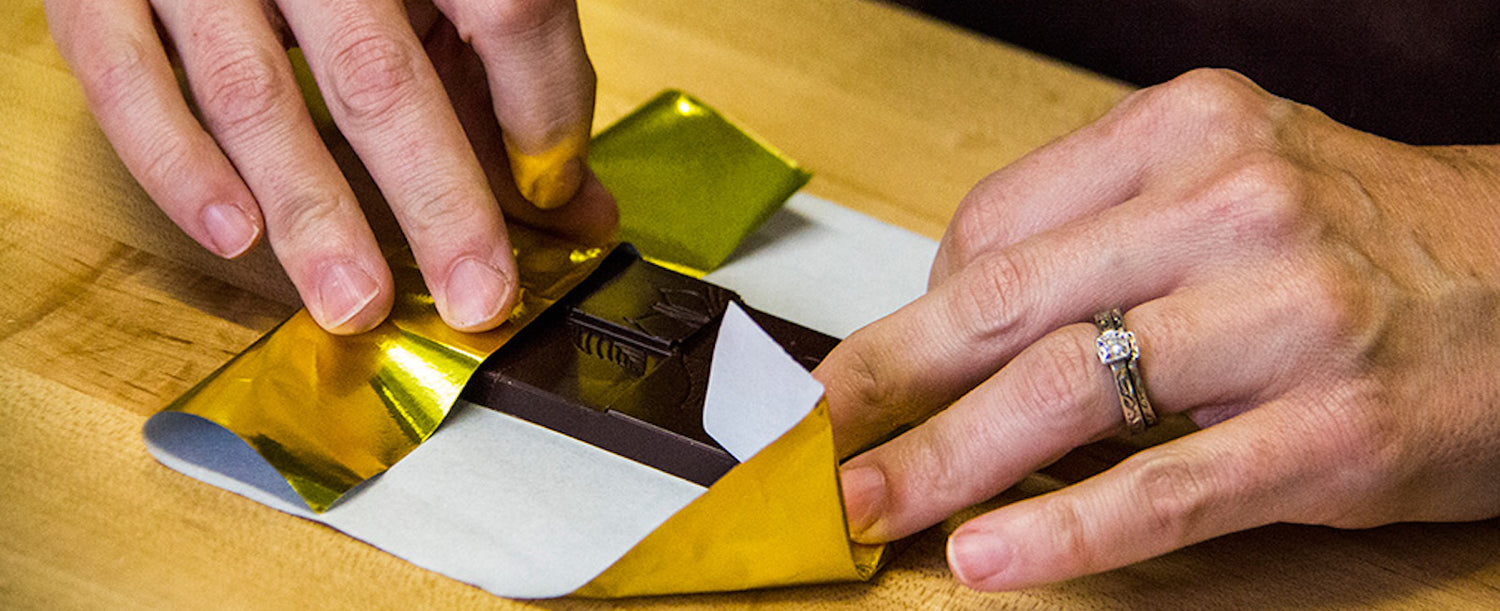 Wrapping a chocolate bar in our gold wrapper.
