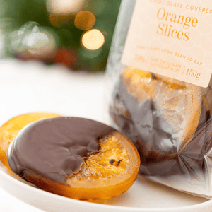 Close up of beautiful chocolate covered candied orange slices made with bean to bar single origin dark chocolate