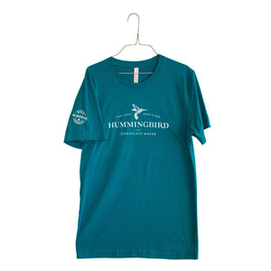 Deep Teal unisex t-shirt printed with Hummingbird Chocolate Maker logo on front chest and Made in Almonte logo on the right arm