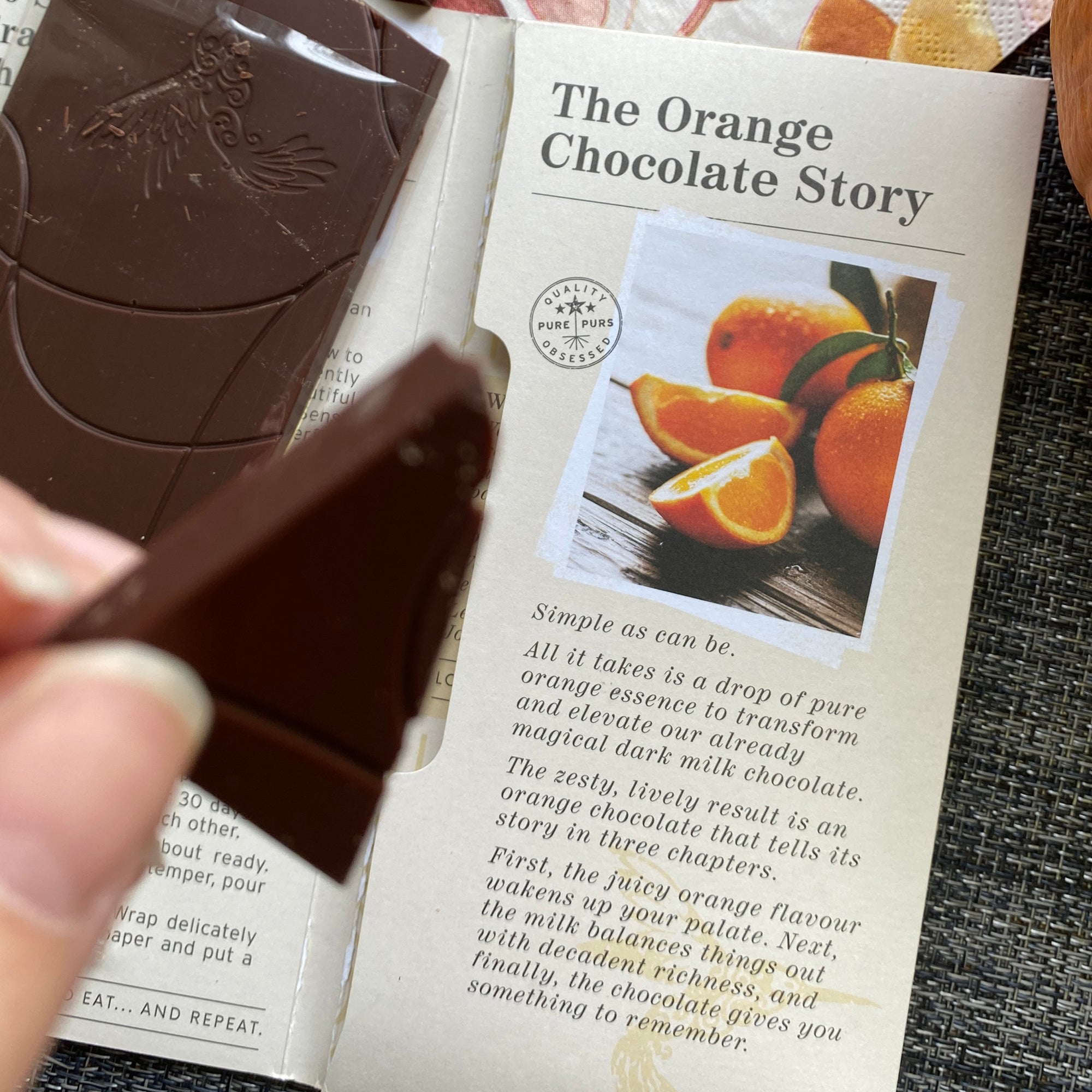 Opened orange chocolate bar, revealing story behind this zesty flavour combination and delicious chocolate indulgence
