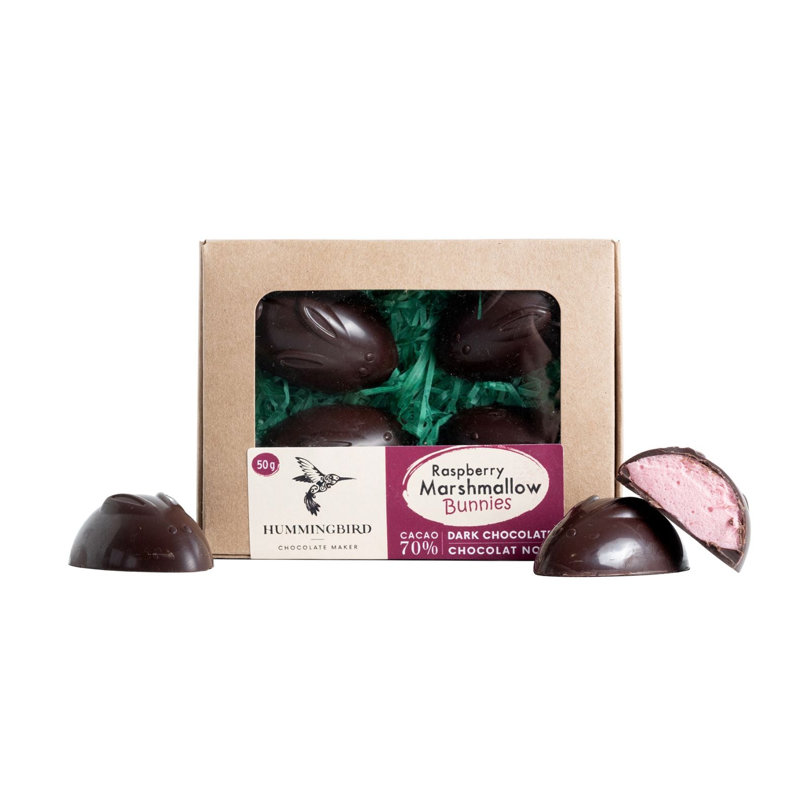 Cross-section of Raspberry Marshmallow Bunnies in front of packed product revealing beautiful pink marshmallow inside dark chocolate bunnies